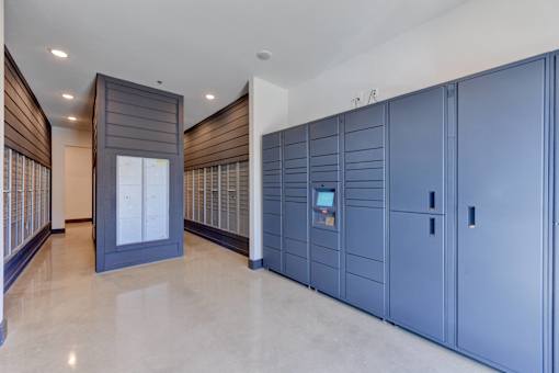 A row of blue lockers are lined up in a room.