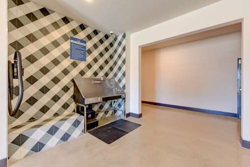 A kitchen with a checkered tile backsplash and a sink.