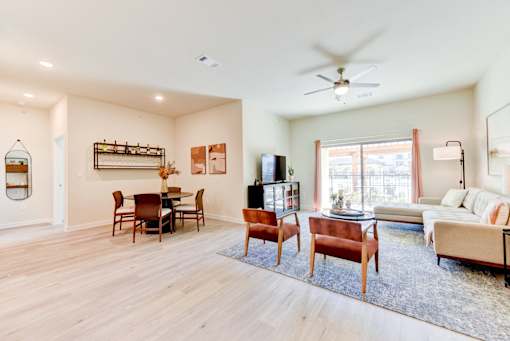 A living room with a dining table and chairs.