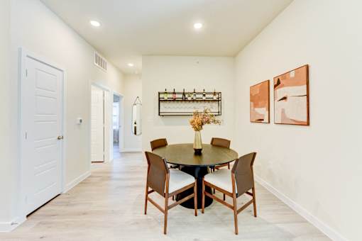 A dining room with a table set for four.