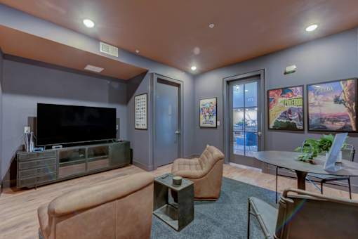 A living room with a brown couch and a television.