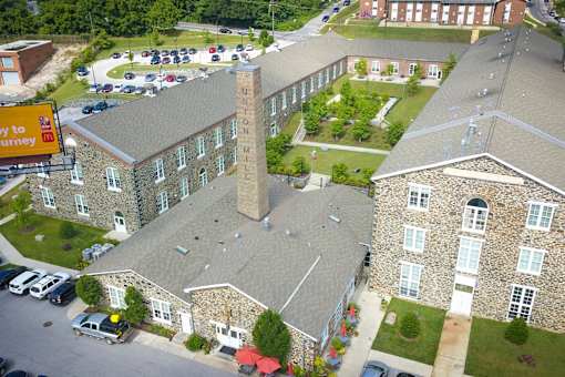 A large building with a tall tower in the middle of it.