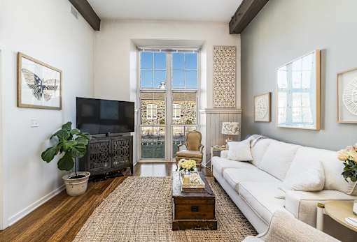 A living room with a white couch and a television.
