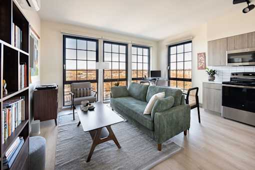 A living room with a green couch and a coffee table.