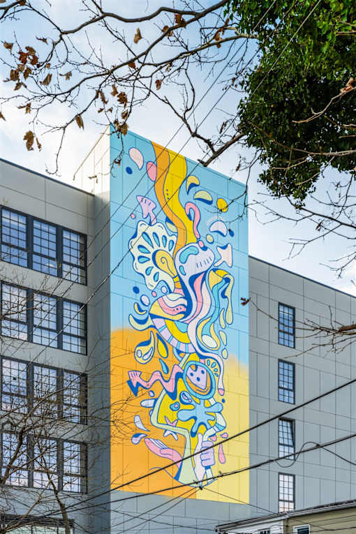 A large mural of a colorful abstract design on a building.
