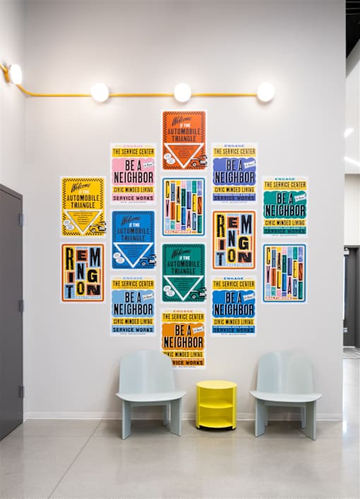A wall of posters with the word "BE A NEIGHBOR" on them.