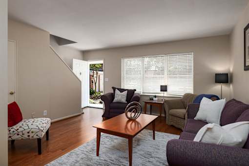 A living room with a couch, chair, and table.