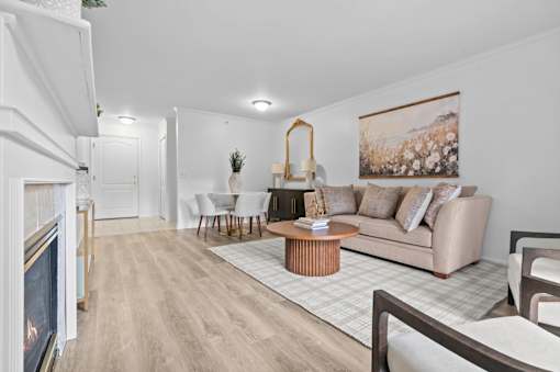 Modern living and dining area with fireplace at Regents Club of Troy Apartments, Michigan