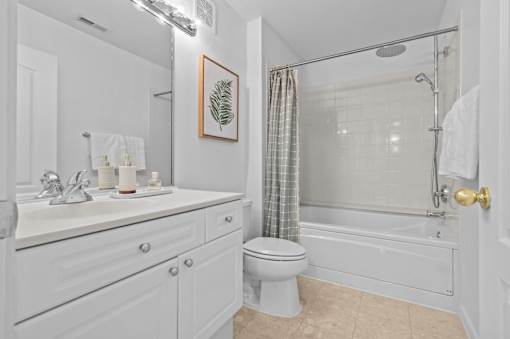 Bathroom with white vanity and tub shower combo at Regents Club of Troy Apartments, Troy, Michigan