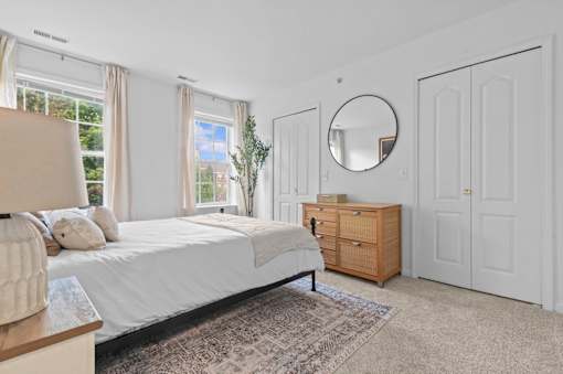 Spacious bedroom with natural light and closet doors at Regents Club of Troy Apartments, Troy, MI