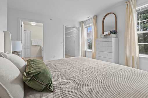 Master bedroom with ensuite bathroom and walk-in closet at Regents Club of Troy Apartments, Troy, Michigan