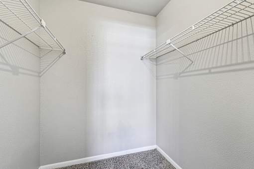 Empty room with two wire shelves.