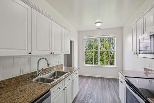 A kitchen with a sink and a window.