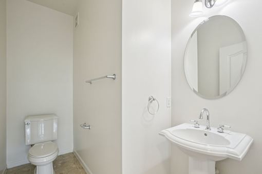 A white toilet and sink in a bathroom.