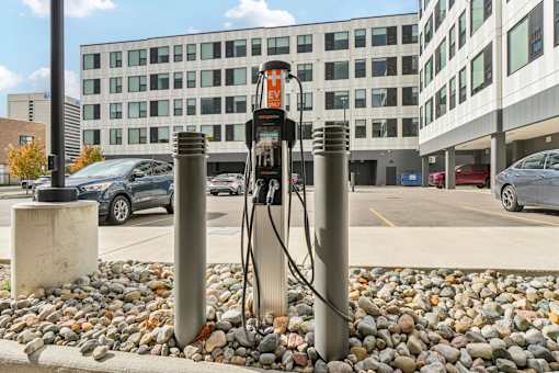 A charging station for electric vehicles is located in front of a parking lot.