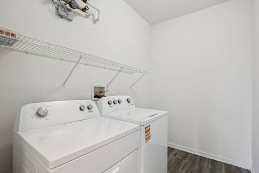 A white washing machine and dryer in a small laundry room.