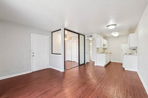 A room with wooden floors and white walls.