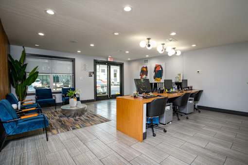 A modern office space with a reception desk and chairs.