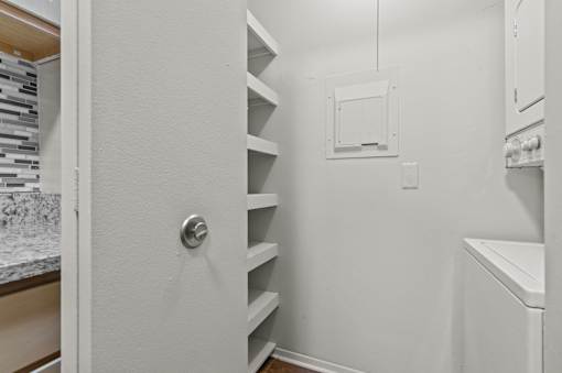 A white door with a silver handle is open.
