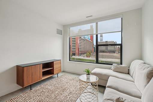 Room with white couch at Lafayette West Apartments, Detroit