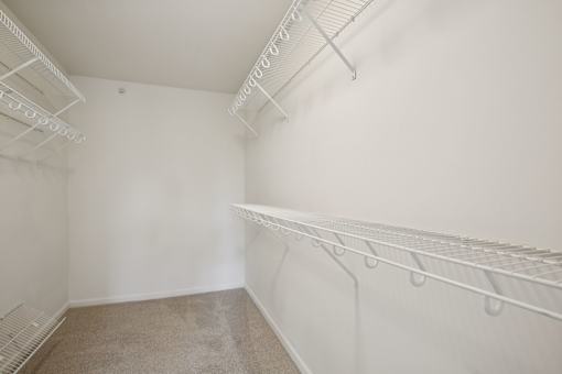 Empty room with white walls and carpeted floor.