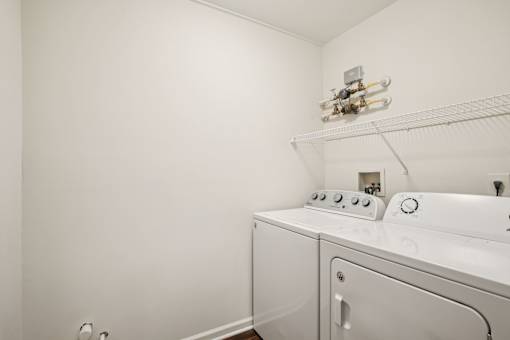 A white washing machine and dryer in a small laundry room.