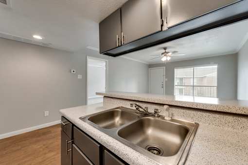 A kitchen with a sink and a window.