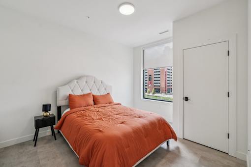 Bedroom with bed at Lafayette West Apartments, Detroit, MI, 48207