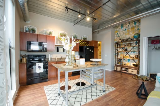 a kitchen with a table in the middle of a living room at Ann Arbor City Club, Ann Arbor, MI