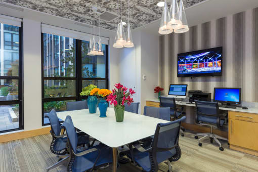 a conference room with a table and chairs and a tv on the wall at Ann Arbor City Club, Ann Arbor Michigan