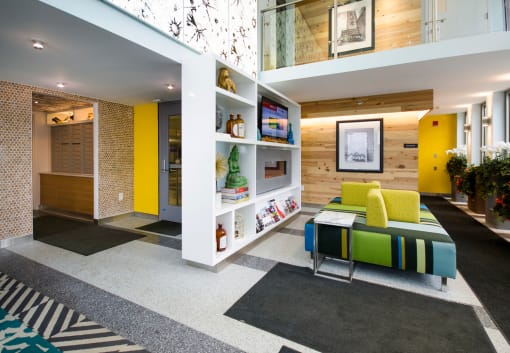 a living room with yellow walls and a green couch at Ann Arbor City Club, Michigan, 48104