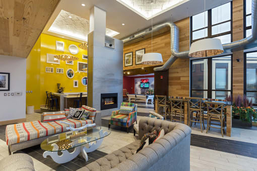 a living room with couches and chairs and a fireplace at Ann Arbor City Club, Ann Arbor, 48104