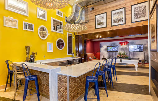 a bar with blue chairs at a restaurant with a pool table at Ann Arbor City Club, Ann Arbor, MI 48104