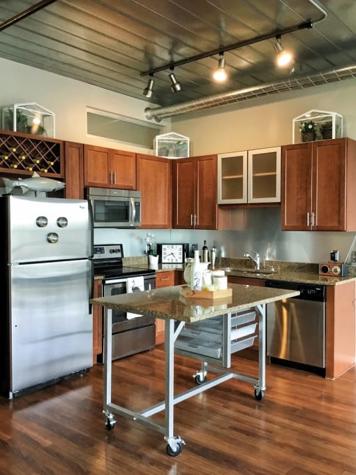 a kitchen with stainless steel appliances and a table at Ann Arbor City Club, Ann Arbor
