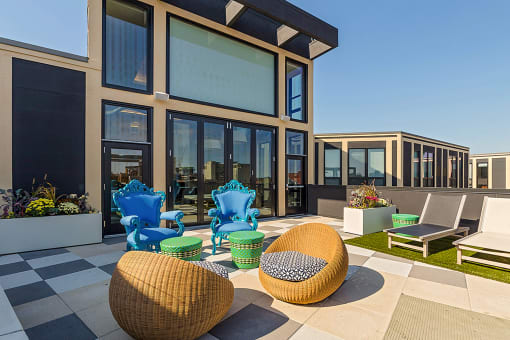 a patio with chairs and tables outside of a building at Ann Arbor City Club, Ann Arbor Michigan