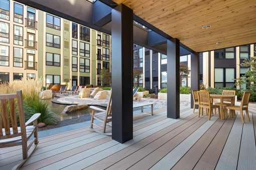 a patio with a table and chairs on a deck at Ann Arbor City Club, Ann Arbor, MI 48104