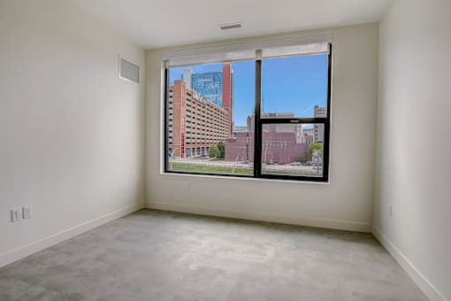 Room with large window at Lafayette West Apartments, Detroit