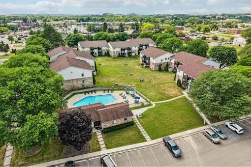 A bird's eye view of a residential area with a swimming pool.