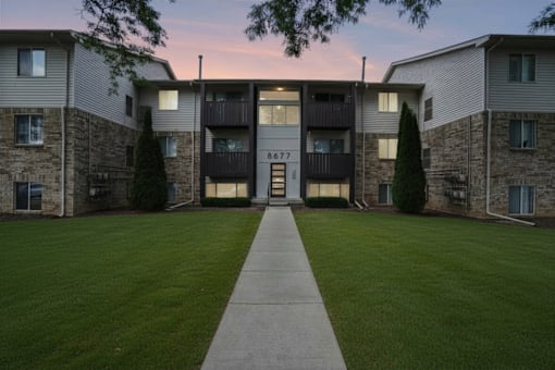 The image shows a building with the number 8677 on it.