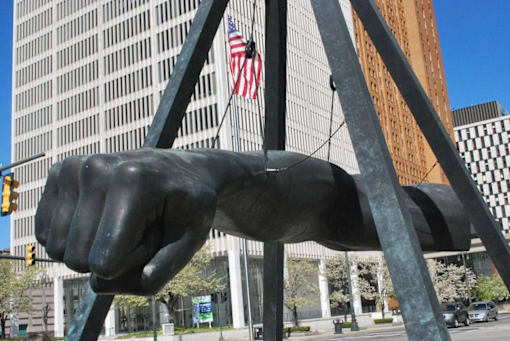 a largeveltveltvelt statue in front of a tall building at City Club Apartments Lafayette Park, Detroit, MI 48207