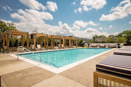 a swimming pool at a hotel with chairs around it at City Club Apartments Lafayette Park, Detroit