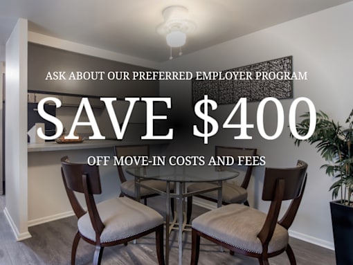 A room with a dining table and chairs is advertised to save $400 on move-in costs and fees.