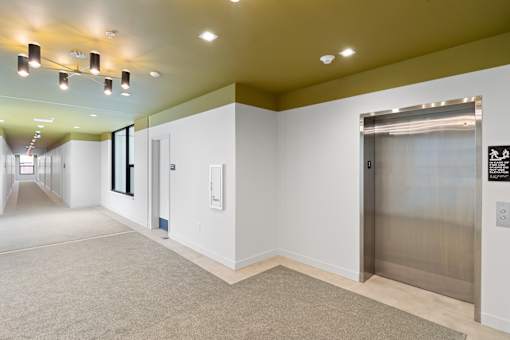 Hallway with elevator at Lafayette West Apartments, Detroit, MI, 48207