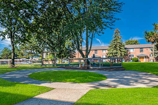 A park with a grassy area and a walking path.