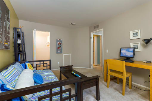 a living room with a couch and a television at Village Club of Farmington Hills, Michigan