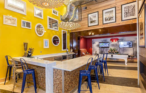 a bar with blue chairs at a restaurant with a pool table at Ann Arbor City Club, Ann Arbor, 48104