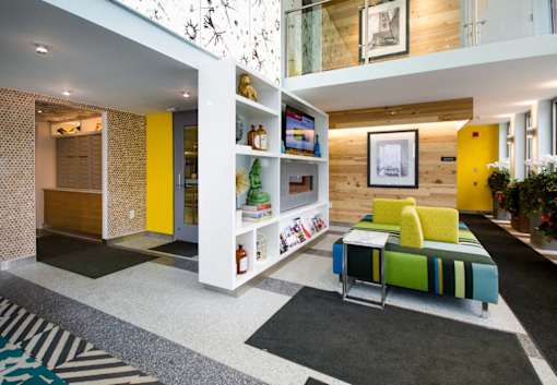 a living room with a couch and a table at Ann Arbor City Club, Ann Arbor, MI