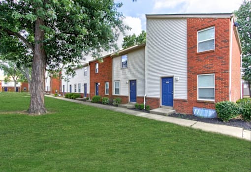 A long concrete walkway leads to a row of houses.