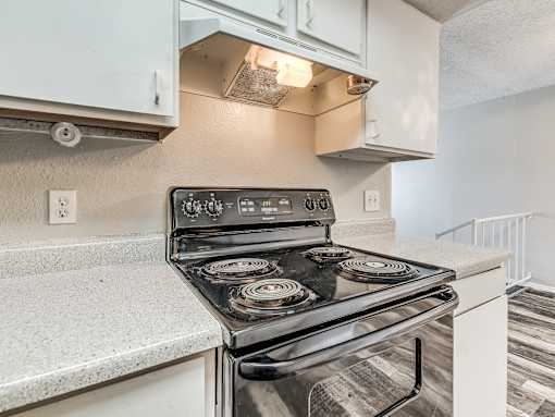 A modern kitchen with a stove top oven.