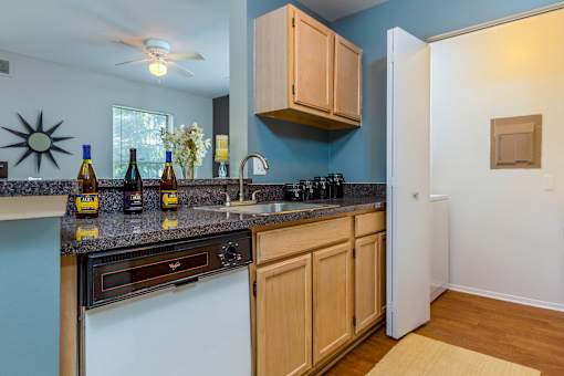 A kitchen with a white oven and wooden cabinets.
